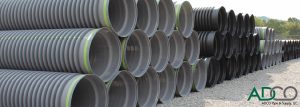 Stacks of HDPE pipes, commonly used in culverts.